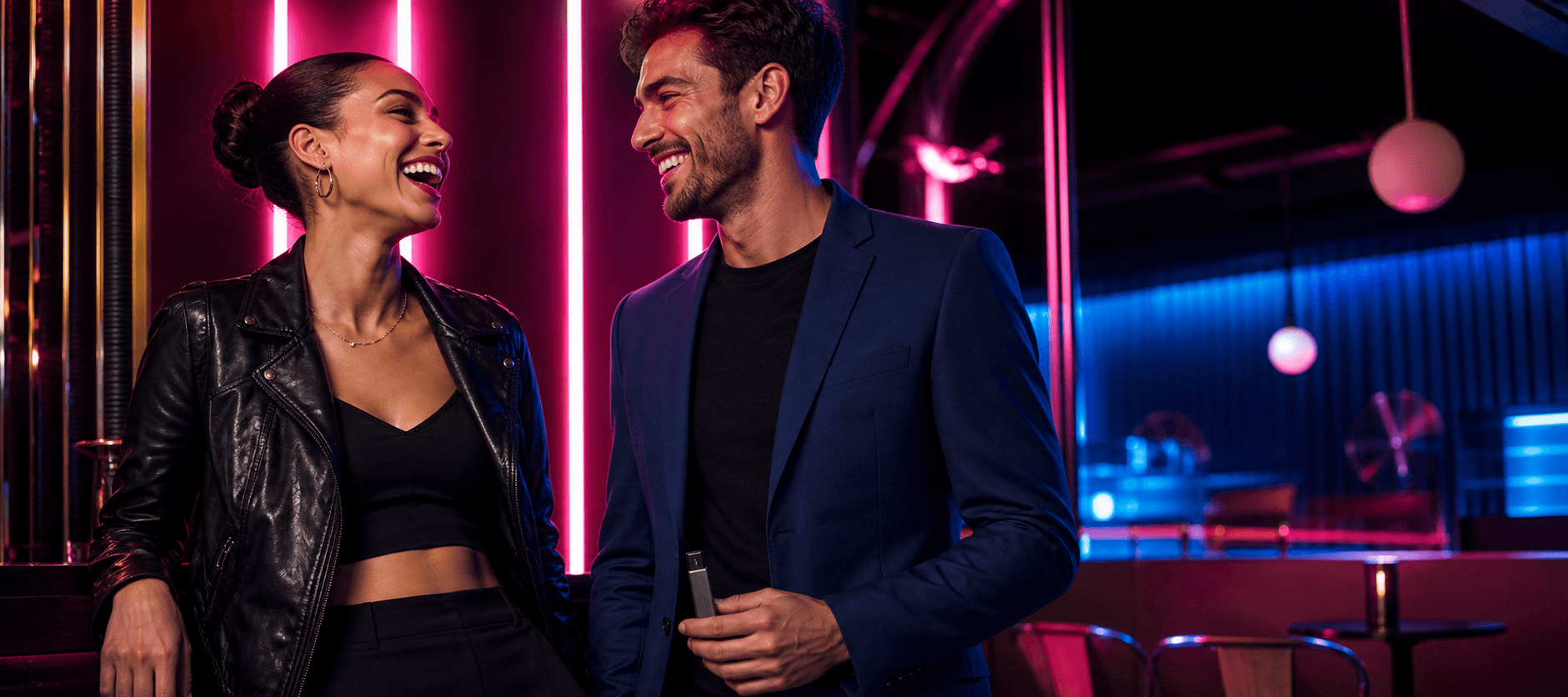 Two adults talking under neon lights